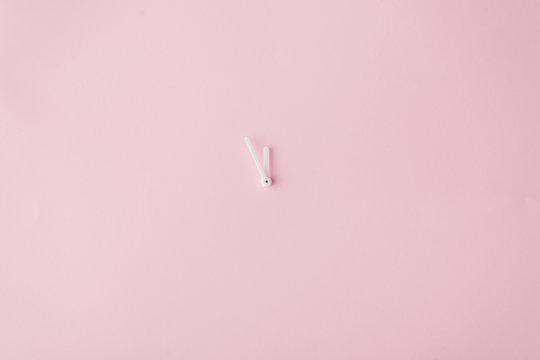 Fototapeta Clock hands on pastel pink painted wall. Minimal time concept.