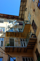 Traditional facade of house with old windows and balconies. Old authentic courtyard of Lviv, Ukraine.