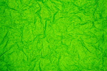 Fototapeta premium ABSTRACT RANDOM BACKGROUND OF CREASED CRUMPLED BRIGHT GRASS GREEN TISSUE PAPER