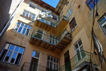 Traditional facade of house with old windows and balconies. Old authentic courtyard of Lviv, Ukraine.