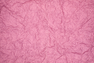 ABSTRACT RANDOM BACKGROUND OF CREASED CRUMPLED PALE PINK TISSUE PAPER