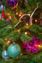 Christmas Tree decorated in a purple theme with decorative purple and cyan items in sight