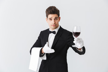 Handsome young waiter wearing tuxedo