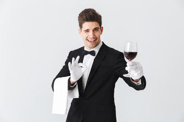 Handsome young waiter wearing tuxedo