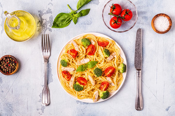Plate of spaghetti tomato broccoli chicken