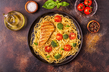 Plate of spaghetti tomato broccoli chicken