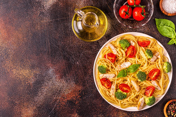 Plate of spaghetti tomato broccoli chicken