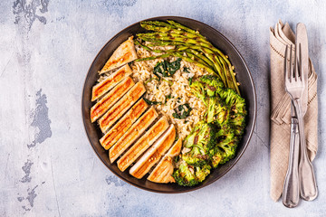 Grilled chicken breast with brown rice, spinach, broccoli, asparagus