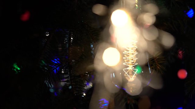 Sparklers are lit against the background of light bulbs flashy flashlights background. Close up