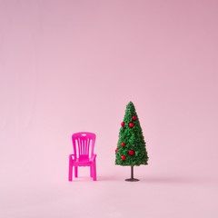 Christmas tree with pink chair. Minimal New Year concept.