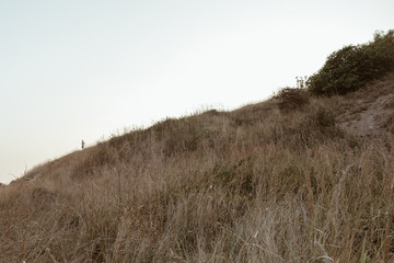 alone man on the cliff and mountain