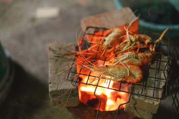 Grilled shrimp, prawn barbecue over Asian charcoal stove