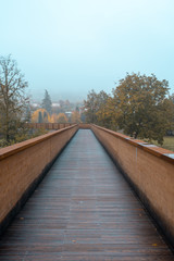Footbridge made by wood in autumn in Italy