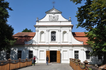 Fototapeta na wymiar Tourists going to the baroque church, Zwierzyniec near Zamosc Poland, travel destination