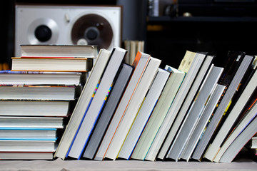 Book, stack of hardback books on table. Top view.