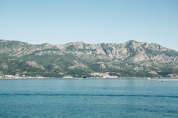 Fototapeta na wymiar Beautiful view of the landscape of Montenegro. Sea and mountains. Buildings in the distance.