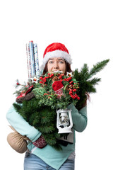 Photo of woman in Santa's cap with Christmas tree, lantern, wrapping paper in hands