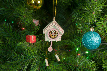 Wooden toy clock with pendulum on Christmas tree