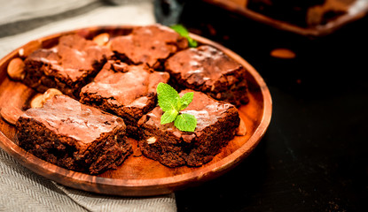 freshly prepared home fresh brownies with nuts and figs, on a black background