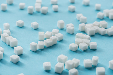 white sugar cubes on blue background