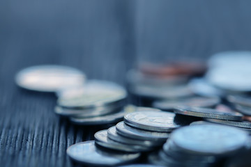 Row of coins on wood background for finance and Saving concept,Investment, Economy, Soft focus and dark style.