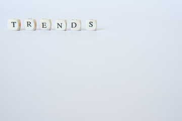 The word Trend is laid out on a white surface. Location in the corner of the frame.