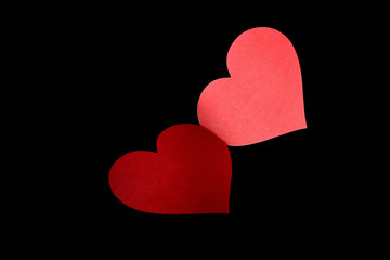 two red hearts on a black background
