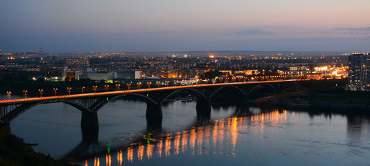 Naklejka premium NIZHNY NOVGOROD, RUSSIA - AUGUST 28, 2018: View to Okskiy Bridge and lower city from Okskiy Syezd at time of sunset
