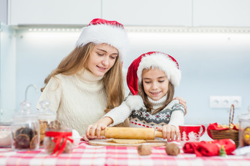 happy family in Christmas caps preparing a festive dinner