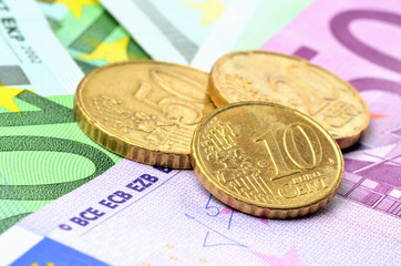 Ten, twelve and thirty euro cents coins on euro banknotes