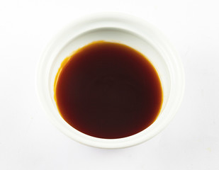 White dish with soy sauce on white background, ingredient