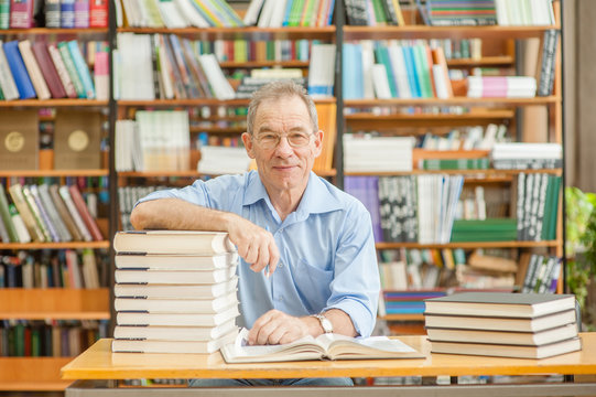 portrait of an elderly smiling man in a library