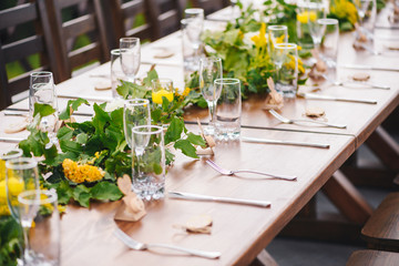Table set up for a special event/wedding. Yellow and green fresh flowers