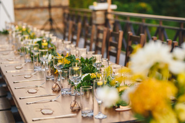 Table set up for a special event/wedding. Yellow and green fresh flowers