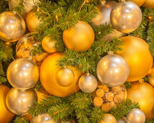 Christmas tree decorated with bright yellow and orange balls