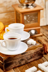Fototapeta na wymiar Two cups of coffee espresso near sugar cube