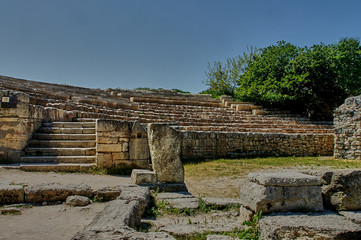 Sevastopol, Crimea, Russia - May 12, 2015: Khersoneus Tauride / Ruins of the ancient amphteater. Stone tribunes of the amphitheater against the blue sky.