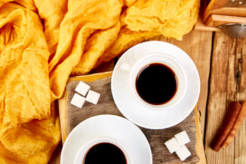 Two cups of coffee espresso near sugar cube