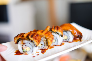 Anago (Grill Eel) or Unagi sushi with japanese sauce serve on white plate - Japanese traditional food concept for background or texture.