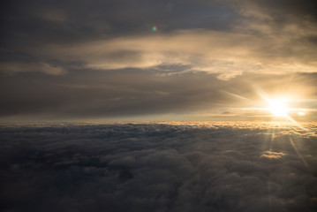 Sun over the clouds during a flight