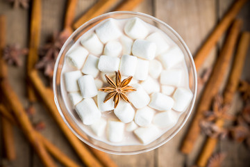 Chocolate martini with spices and marshmallow on the rustic background. Selective focus. Shallow depth of field. 