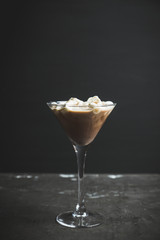 Chocolate martini with spices and marshmallow on the rustic background. Selective focus. Shallow depth of field. 