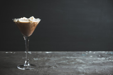 Chocolate martini with spices and marshmallow on the rustic background. Selective focus. Shallow...