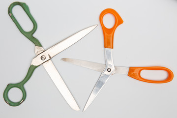 Scissors for different purposes and sizes on a white background, vintage and new, plastic and metal, top view