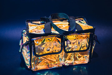 Professional bag for cosmetics on black. Iridescent reflection effect plastic