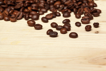 Close up of coffee beans on a wooden background