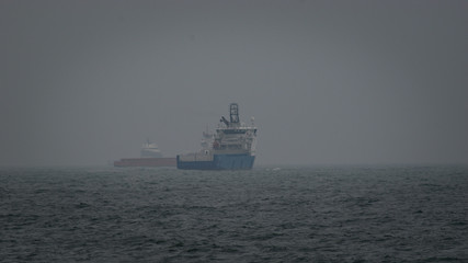 ships;boats;vessel;sea;water;waves;fog;