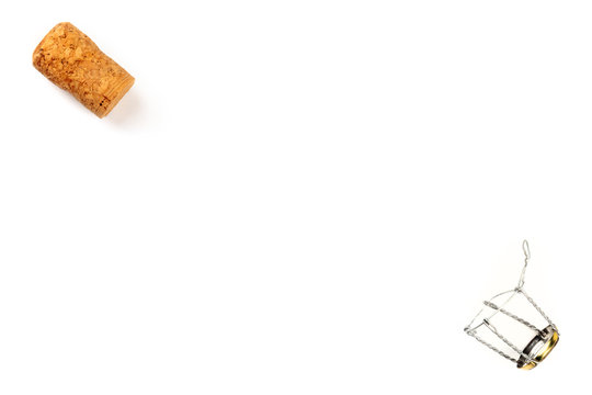 A photo of a champagne cork and closure, shot from the top on a white background with a place for text