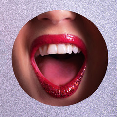 Winter sale concept. Red lips in silver paper hole with metalic effect. New year celebration background. Square crop.