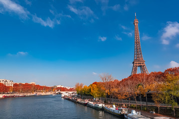 Paris, Eiffel tower in autumn, panorama with red trees 

